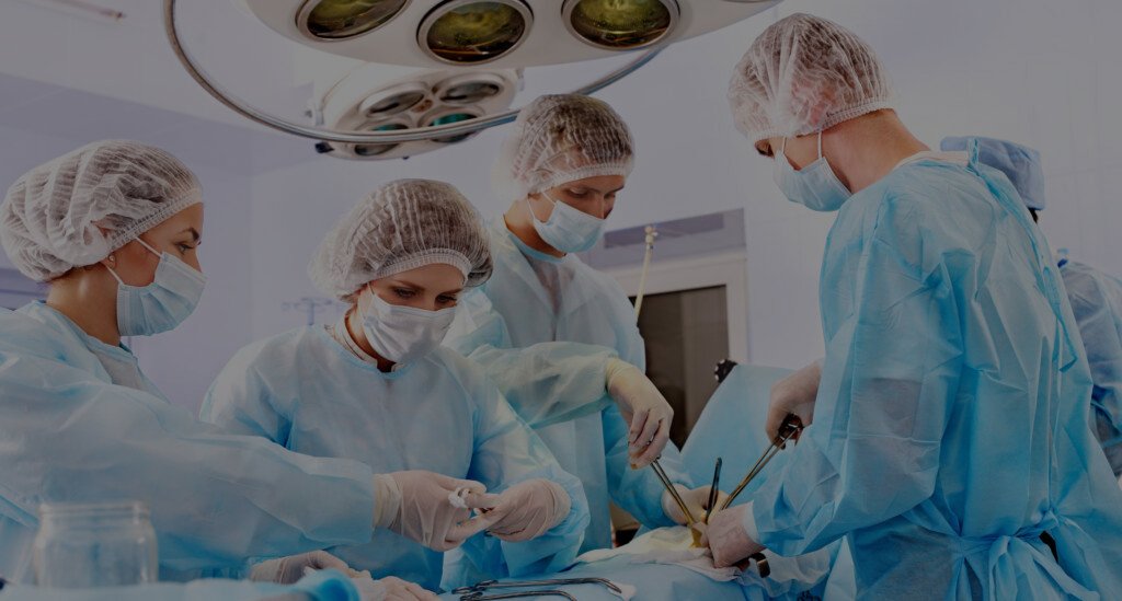 Team surgeon at work in operating room.